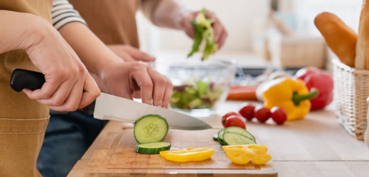 Couple making food and using chopping board