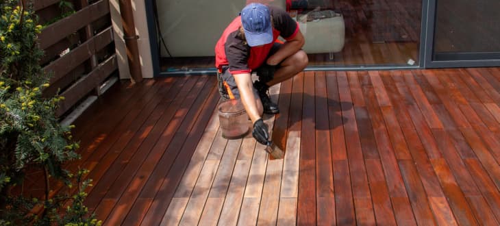 Man staining composite decking