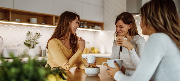 friends chatting in their open plan kitchen
