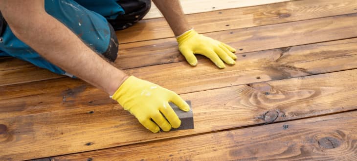 man sanding decking