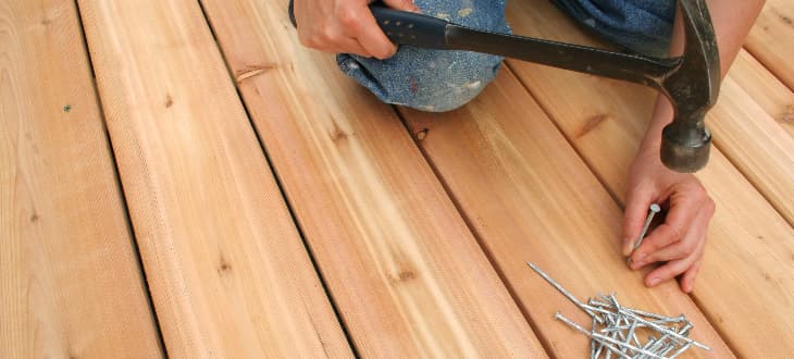 man fixing garden decking