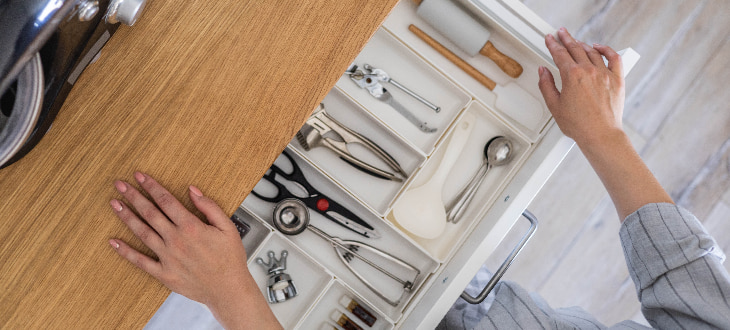 woman opening kitchen drawers