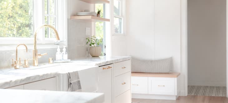 white, modern kitchen with gold accents