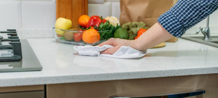 person cleaning laminate worktop