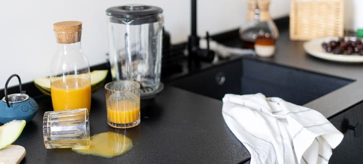 orange juice spilt on laminate worktop