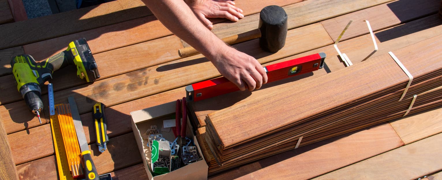 man building garden decking