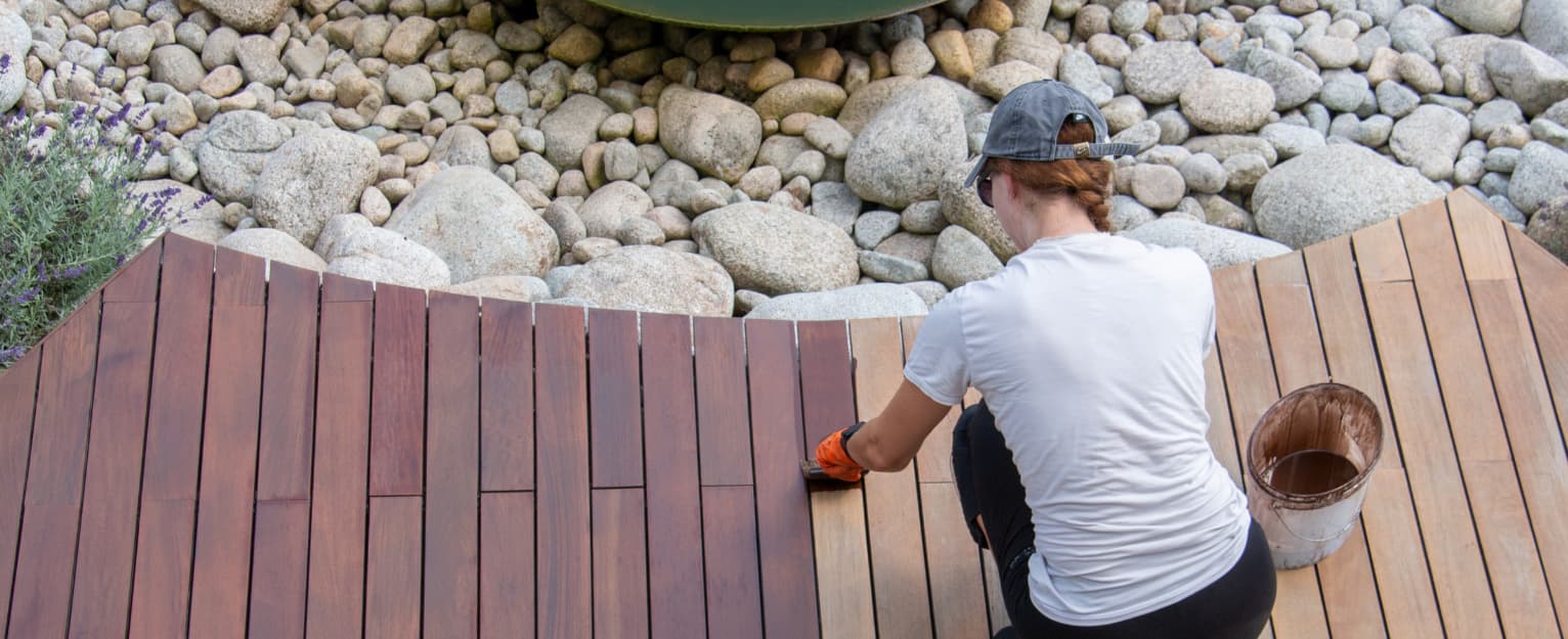 Woman painting decking