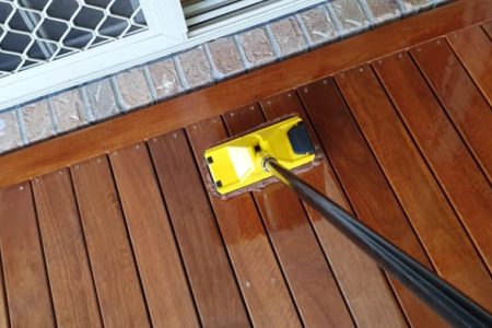 Someone cleaning timber decking