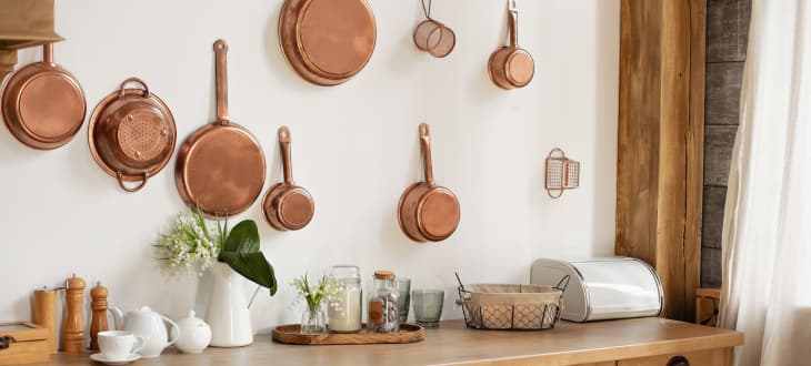 chic pots and pans hung on wall