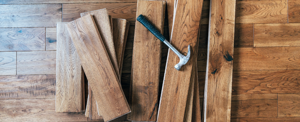 wooden floor slabs and hammer layed on top