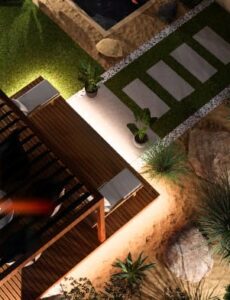 Aerial view of a modern landscaped garden with a pergola seating area, pathway and decorative plants at night