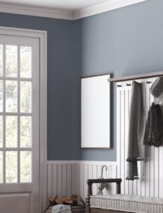 White internal doors in a modern hallway with blue walls, glazed French doors, and decorative wall panelling
